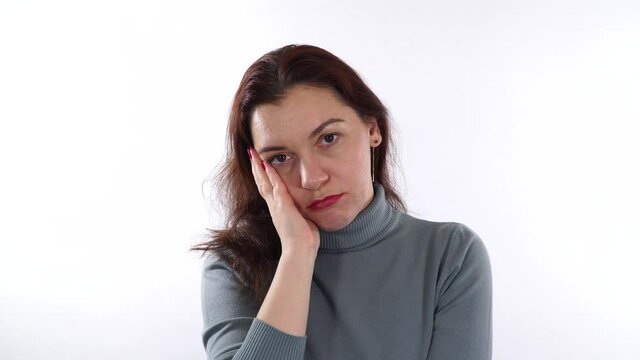 Cheek gesture. Boredom gesture. Brunette caucasian woman using her hand to support head - it's signal that boredom has become.