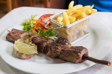 The traditional Madeira dish espetada or beef on a skewer, seasoned with salt, garlic and bay leaves, is roasted in a brazier and served directly from the skewer. 