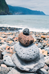 The peace, beauty, stability and tranquility - the stack of zen stone on the pebble beach on the Atlantic ocean coast of Madeira island