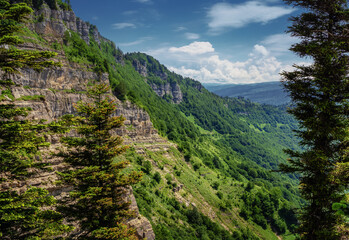 Fototapeta na wymiar View of the slope of the Rachin ridge and the road to Tshra Jvari. Georgia (Saqartvelo)