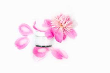 Fototapeta na wymiar Natural cosmetic. Cream and peony flower in a bath with milk. Conceptual photo: the best cosmetic tool for body and face care. Gentle care, mockup.