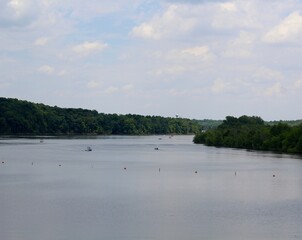 The boats on the lake in the countryside on a sunny day.