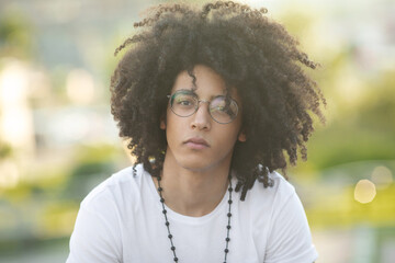 Arabian model looking young guy looking to camera. Man with Curly hair.