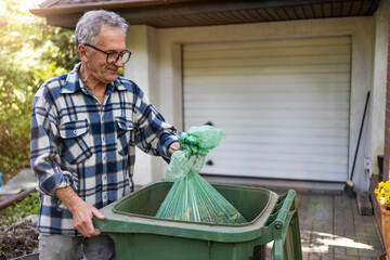 Senior man taking out garbage
