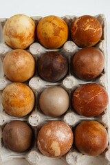 box of twelve original, unique colorful dragon or dinosaur looking like chicken Easter eggs, dyed with natural products (red wine, tea, coffee, carrots, turmeric, soy sauce