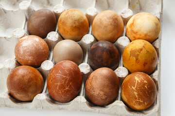 box of twelve original, unique colorful dragon or dinosaur looking like chicken Easter eggs, dyed with natural products (red wine, tea, coffee, carrots, turmeric, soy sauce)