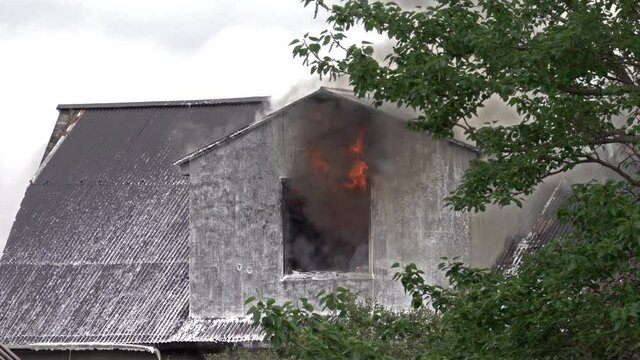 Thick smoke billowing from roof of burning house in Reykjavik Iceland