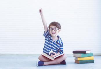 A boy reading books at home