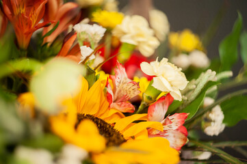 Flower arrangement with a sunflower on a black background. Macro photo. Stylish flowers for sale....