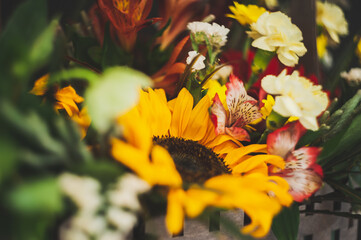 Flower arrangement with a sunflower on a black background. Macro photo. Stylish flowers for sale....