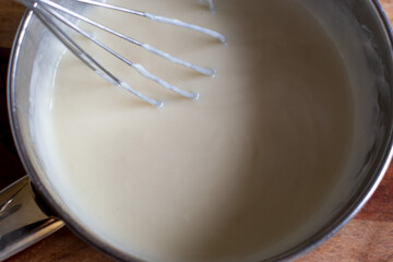 making white sauce with a whisk