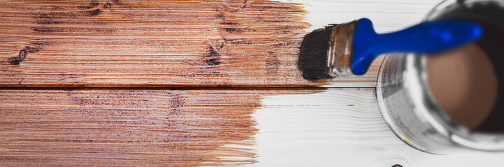 panorama of a wooden board with a brush and brown glaze
