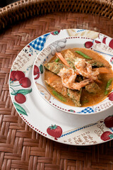 Thai popular food. Sour curry in the pot on basketry.