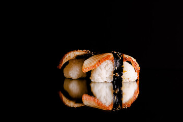 Sushi and role on the reflective surface, black background. concept of healthy traditional Japanese cuisine. selective focus. - Powered by Adobe