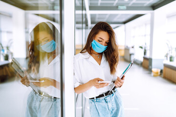 Office worker with face mask working in the office. The concept of preventing the spread of the epidemic and treating coronavirus, pandemic in quarantine city. Covid-19.