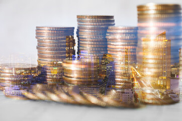 double exposure of city with row of coin stack for business investment finance banking and money saving concept.