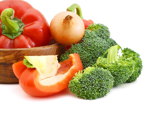 Broccoli , onion and red peppers in wooden bowl  on white