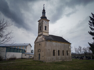 An old abandoned church building in a dilapidated condition against a gloomy sky during the cloudy day.