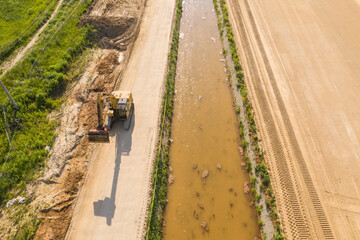 Aerial view of machinery and mine equipment near road on sandy surface. Warsaw Wilanow