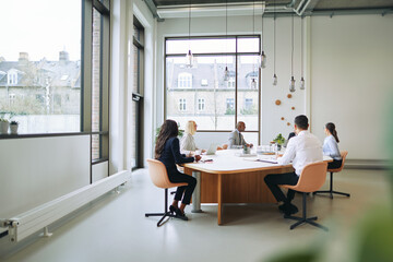 Diverse businesspeople having a meeting together in an office bo