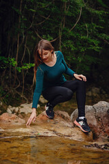 Female tourist in the forest resting near the river