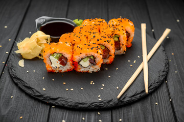 Philadelphia roll with fresh fish on black background