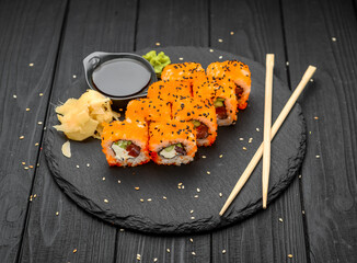 Philadelphia roll with fresh fish on black background