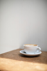 cappuccino or Latte art coffee made from milk on the wood table in coffee shop