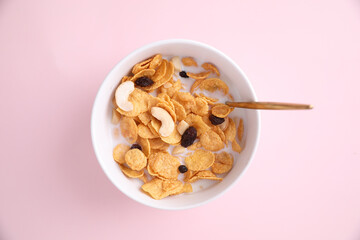 Cereal dessert with corn oat and dry fruits isolated in pink background