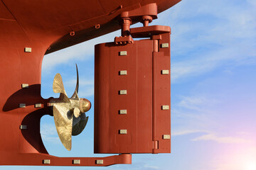 Propeller and rudder of Large cargo ships, aft of the commercial ocean ship in floating dry dock yard, completed recondition painting over hull cleaning in dock yard terminal, ready to delivery