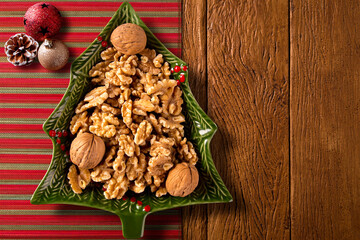 Walnuts in a Christmas Tree Pot on a wood background. Top View.