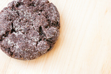Top close up view of chocolate cookies on wooden table.Freshly baked choco biscuites.
