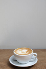cappuccino or Latte art coffee made from milk on the wood table in coffee shop