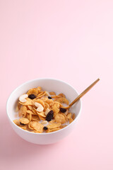 Cereal dessert with corn oat and dry fruits isolated in pink background