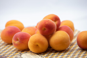 Ripe apricots on a beige tray