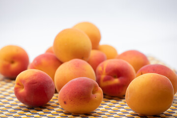 Ripe apricots on a beige tray