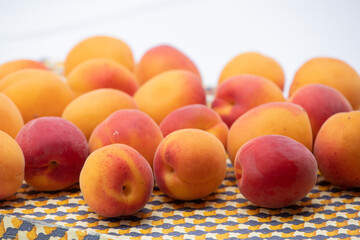 Ripe apricots on a beige tray