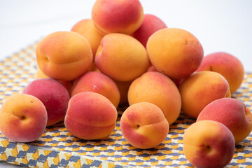 Ripe apricots on a beige tray