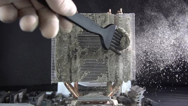 Dust pollution. Cleaning the processor radiator sink from dust. Antistatic brush. Slow motion.