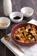 Cereal dessert with corn oat and dry fruits isolated in wood background