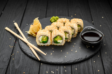 Sushi rolls in sesame with avocado and cream cheese