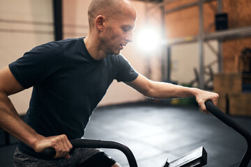 Man riding a stationary bike in a gym