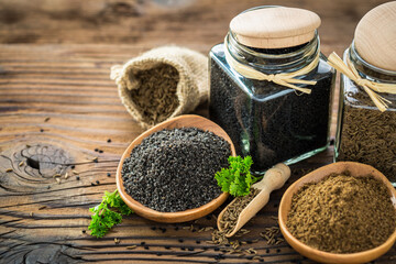 Fresh cumin seeds and powder on the wooden table