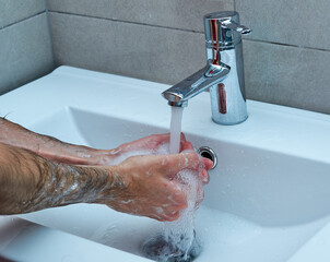 Washing hands rubbing with soap man for corona virus prevention.