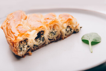 Filo Spinach and Feta Twist Pie in the iron pan after oven. Authentic Greek bakery. With spinach, mizithra and feta cheeses.