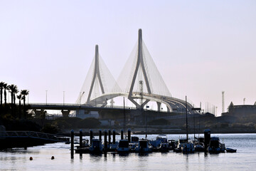 Obraz premium fishing boats in Puerto Real with the bridge of the Constitution in the background, called La Pepa, in the capital Cadiz. Andalusia. Spain. Europe.