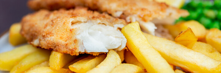 Traditional English Food such as Fish and Chips with green peas served in the Pub or Restaurant - obrazy, fototapety, plakaty