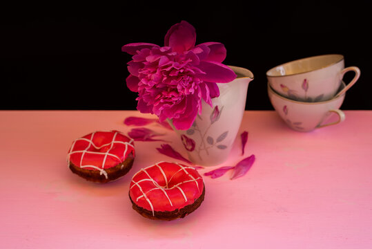 Flat photo with cups, strawberry donut and peony flower