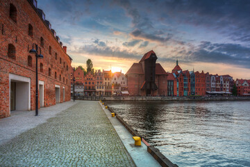 Old town in Gdansk with historical port crane over Motlawa river at sunset, Poland.