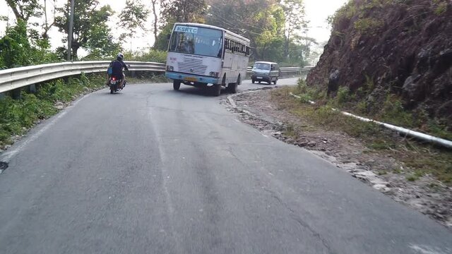 Slow Motion of Indian Bus Racing Down Winding Road outside Munnar, Kerala, India